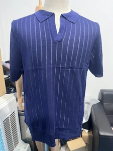 Detail of navy blue knit polo shirt featuring vertical hollow mesh stripe pattern