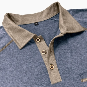 Close-up of polo shirt collar with khaki contrast fabric and wooden texture buttons