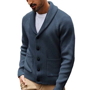 Detail of shawl collar and knitting texture on a men's dark grey blue cardigan sweater