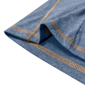 Close-up of blue heathered knit fabric with brown reinforced flatlock stitching detail