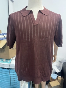 Detail of dark brown knitted polo shirt showing vertical mesh stripe texture and V-neckline