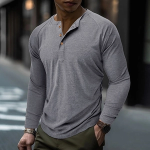 Detail shot of men's gray Henley shirt with three brown buttons and raglan sleeves