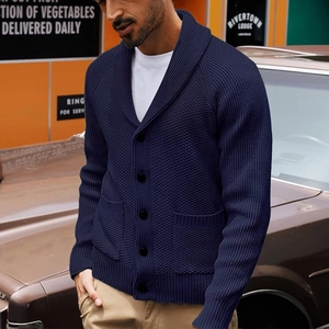Close-up of navy blue knit cardigan sweater with shawl collar and vintage button detail