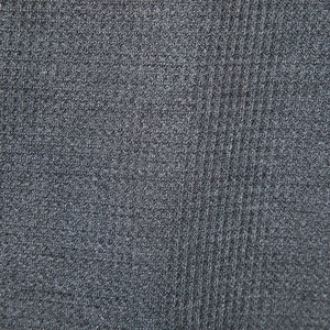 Close-up of deep grey waffle knit fabric texture showing breathable honeycomb weave detail