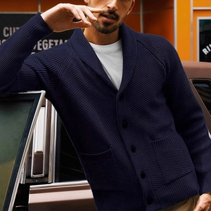 Detail of navy blue shawl collar cardigan with waffle texture and dark buttons