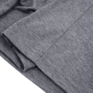 Detailed close-up showing the double-needle hem and overlock stitching on grey knit fabric