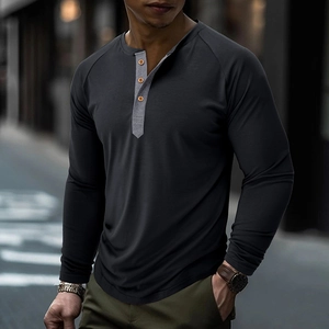 Detailed view of grey long sleeve Henley shirt with contrast collar and wood buttons