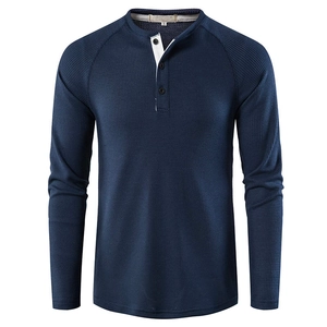 Detail of waffle knit fabric and contrast white lining on navy blue Henley shirt neckline