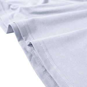 Detail of double-needle stitching and clean hem on light blue knit polo shirt fabric