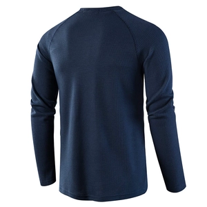Back view of men's dark blue waffle knit raglan sleeve shirt showing textured fabric