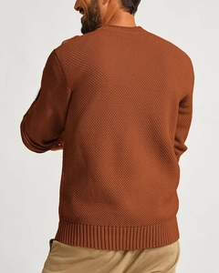 Detailed view of caramel waffle knit sweater showing ribbed cuffs and textured fabric