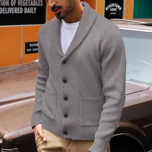 Detail of grey men's shawl collar knit cardigan showing heavy texture and large buttons