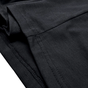Detailed close-up of black cotton knit fabric with reinforced double-needle stitching