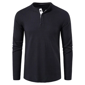 Detailed view of dark grey waffle knit fabric and three-button placket on men's Henley shirt