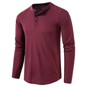 Detailed view of waffle knit fabric and three-button neckline on burgundy Henley shirt