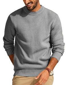 Close-up detail of grey crew neck waffle knit sweater with textured fabric and ribbed cuffs