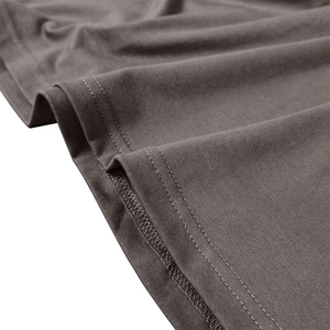 Detail of double-needle stitching and flat-locked seams on dark grey polo shirt hem