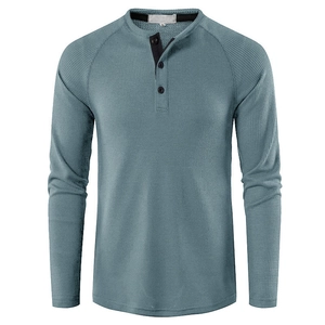 Detailed macro view of waffle knit texture and three-button neckline on grey blue Henley shirt