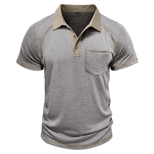 Detail of grey men's polo shirt featuring khaki contrast collar and buttoned chest pocket