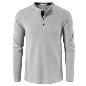 Detail of grey waffle knit Henley shirt neckline with buttons and fabric texture