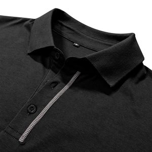 Close-up of black polo shirt collar with white contrast stitching and size S label
