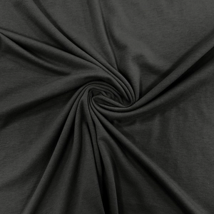 Close-up of black knitted fabric showing fine texture and soft drape of the polo shirt
