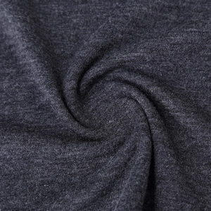 Macro shot of dark gray knit fabric texture with soft heathered marl pattern and smooth drape