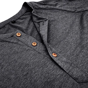 Detail of three metal buttons on deep gray Henley collar men's long sleeve shirt
