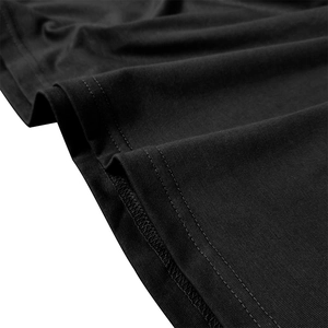 Macro detail of high-quality double-needle hem and overlock stitching on black polo shirt