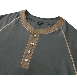 Detail of dark grey Henley shirt neckline with contrast brown collar and four white buttons