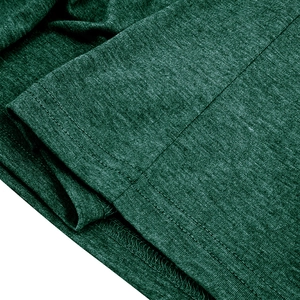 Macro detail of high-quality double-needle hem stitching on dark green knit shirt