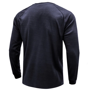 Back view of men's navy blue waffle knit long sleeve shirt with raglan sleeves and rib cuffs