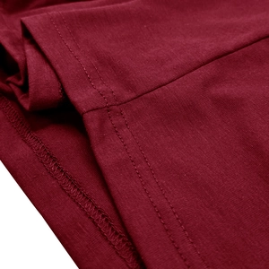Detail of double-needle flat stitching and overlock edge on a burgundy knit Henley shirt