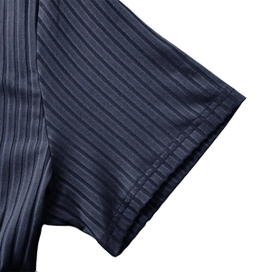 Detail of navy blue ribbed knit sleeve showing high-elasticity fabric and flat stitching