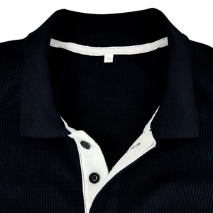 Navy blue waffle knit long sleeve polo shirt with white inner collar detail and buttons