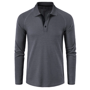 Detailed close-up of dark grey waffle knit fabric texture and collar on long sleeve polo shirt