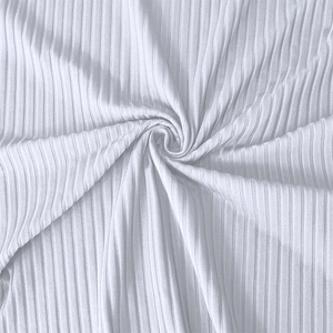 Close-up of white ribbed knit fabric showing vertical texture and soft elastic quality