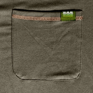 Detailed close-up of olive green knit fabric with contrast stitching on chest pocket