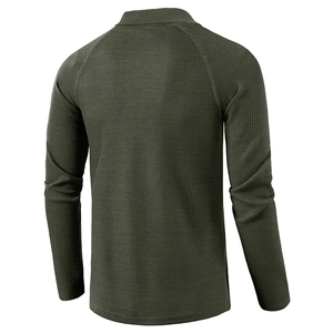 Macro view of men's long sleeve polo shirt showing olive green waffle knit fabric texture