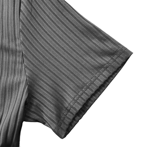 Detailed macro view of the double stitching and vertical ribbed texture on gray sport tee sleeve