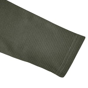 Detailed close-up of waffle knit fabric and double-stitched cuffs on army green polo shirt