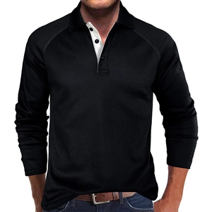 Close-up of black waffle knit long sleeve polo shirt with white contrast collar detail
