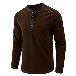 Detail of a brown heavy cotton Henley shirt with gray raglan sleeves and three buttons.