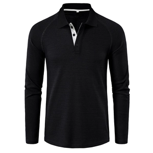 Detail of waffle-knit fabric and three-button placket with white contrast trim on black polo