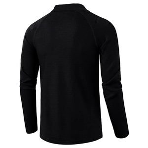 Macro shot of men black waffle knit polo shirt with raglan sleeves and textured fabric
