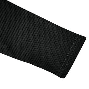Detail of black waffle knit fabric and durable double-stitch cuff on long sleeve polo shirt
