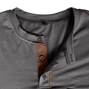 Detailed view of dark grey Henley collar with brown contrast placket and buttons