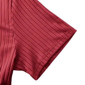 Detail of ribbed knit cuff on men's red sport t-shirt with clean double-needle stitching