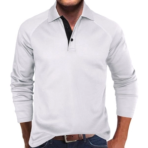 Detail of the white waffle knit texture and black contrast collar on long sleeve polo shirt