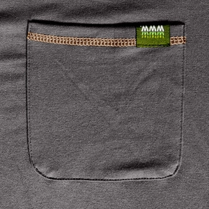 Detail view of dark grey Henley shirt pocket with contrast brown stitching and mini woven tag